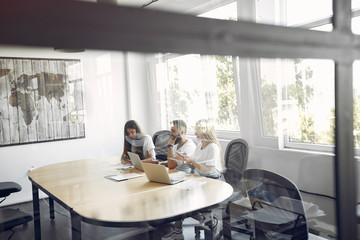 Students create a new project. Team working in a office