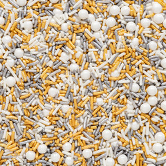 Silver, gold and white macro sprinkles background texture