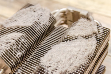 Dirty dusty radiator computer processor close-up on a wooden table. concept of cleaning parts of the computer