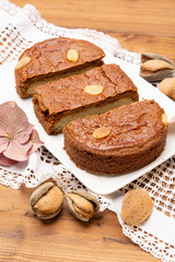 Fresh baked Dutch filled spicy cookies with almonds in autumn colors on dark wooden background