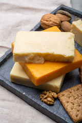 Cheese collection, matured and orange original British cheddar cheese in blocks served with crackers