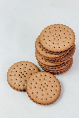 Crispy chocolate chip cookie with holes on the table. Filled Round Cookies
