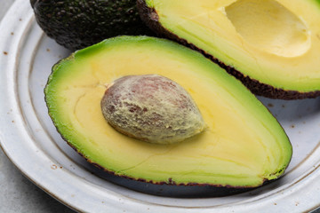 New harvest of fresh ripe hass avocado, cut in half