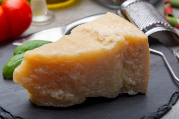 Cheese collection, piece of hard aged Italian parmesan or grana padano cheese with olive oil and tricolore italian pasta
