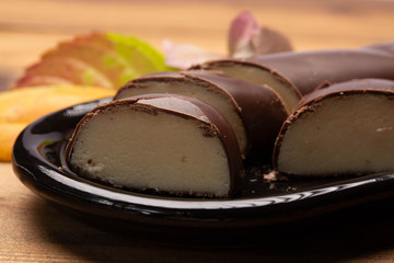 Dutch chocolate candy filled with white marzipan  in autumn colors on dark wooden background