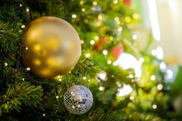 Gold Christmas background of de-focused lights with decorated tree