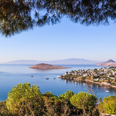 Fototapeta na wymiar Aegean coast with marvelous blue water, rich nature, islands, mountains and small white houses