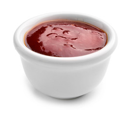 Bowl with tasty barbecue sauce on white background