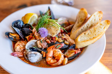 Bouillabaisse Seafood Soup Close-Up with Shrimp, Muscles, Clams, Fish, Fennel and Grilled Bread