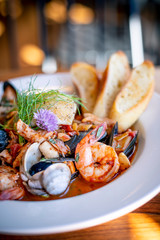 Bouillabaisse Seafood Soup Close-Up with Shrimp, Muscles, Clams, Fish, Fennel and Grilled Bread - obrazy, fototapety, plakaty