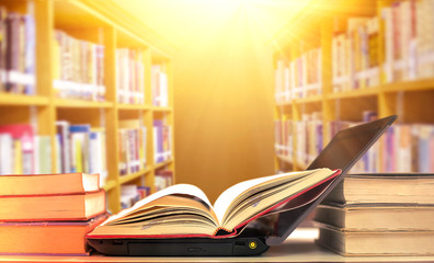 Stack of books in the library and blur bookshelf background