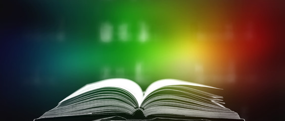 Stack of books in the library and blur bookshelf background