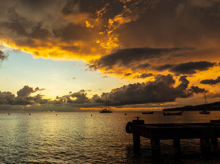 Panorama of beautiful sunset over ocean and sailboats