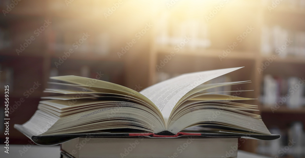 Poster stack of books in the library and blur bookshelf background
