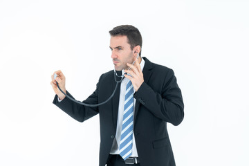 Concentrated male doctor listening heartbeat from stethoscope isolated on white background. Medical and healthcare concept.