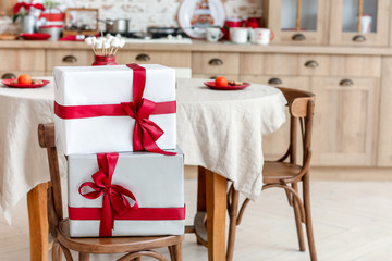 Beautiful Christmas gifts on chair in dining room