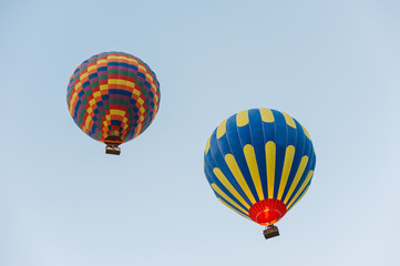 Many colorful hot air balloons flight above mountains - panorama of Cappadocia at sunrise. Wide landscape of Goreme valley in Cappadocia - billboard background for your travel concept in Turkey.