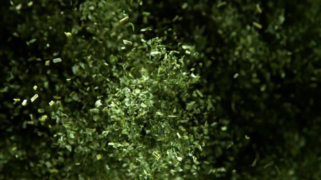 Super slow motion of flying dry parsley or herbs spice. Filmed on high speed cinema camera, 1000 fps