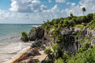 Fototapeta na wymiar Beautiful beach in Tulum Mexico, Mayan ruins on top of the cliff.