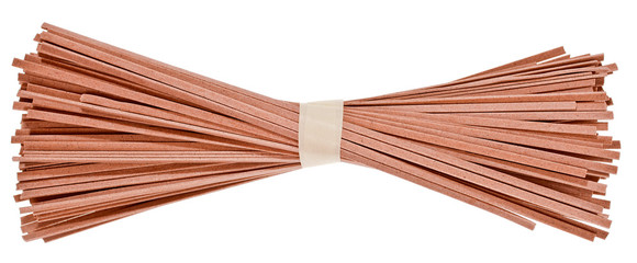 Dried raw japanese soba noodle sticks isolated on a white background. Top view.