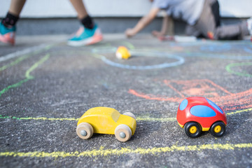 Fototapeta na wymiar kids playing with tiny car toys on the playground