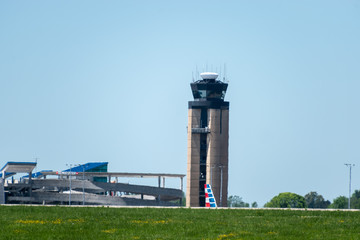 The control tower of Charlotte Douglas International Airport with an American Airlines tail