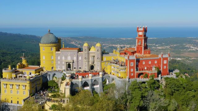 Aerial circling view of the Pena Palace, a romanticist castle in the municipality of Sintra, Portugal, Lisbon district on a sunny day