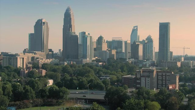 Aerial: downtown Charlotte cityscape and freeway during daytime.  Charlotte, North Carolina, USA. 