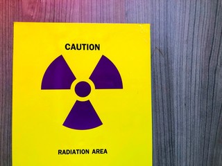 nuclear warning sign on black background