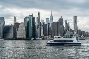 New York City Skyline Along The East River From Brooklyn With Water Transportation And One World Trade Center