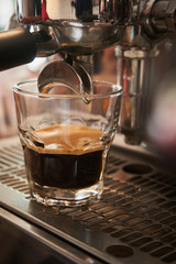  Clo se up coffee glass on the coffee machine drip at the coffee making moment