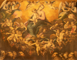 ACIREALE, ITALY - APRIL 11, 2018: The detail of painting of Madonna of Rosary among the angels and franciscan and dominican saints in Duomo by Antonio Catalano (1600).