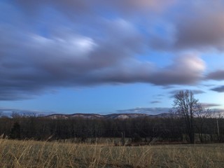 landscape with clouds and snow capped hills