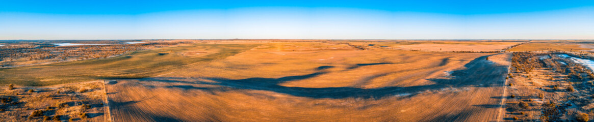 Fototapeta na wymiar Agricultural land at sunset in Australia - wide aerial panorama