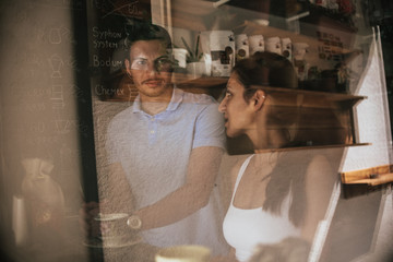 Fototapeta na wymiar Two Caucasian people relaxing in coffee shop during morning coffee
