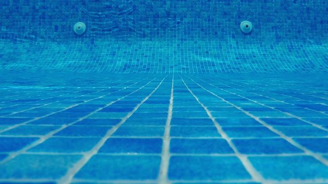 swimming pool underwater, blue water background with copy-space