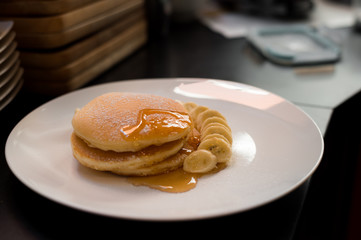 pancakes with banana on white dish