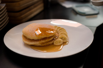 pancakes with banana on white dish