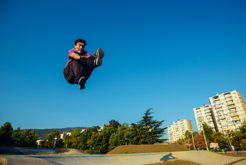 Young man performing a flying kick