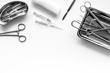 Fototapeta premium Plastic surgery instruments and tools with bandage on white background top view frame copy space