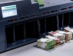 Banknote counting machine with money in front of it