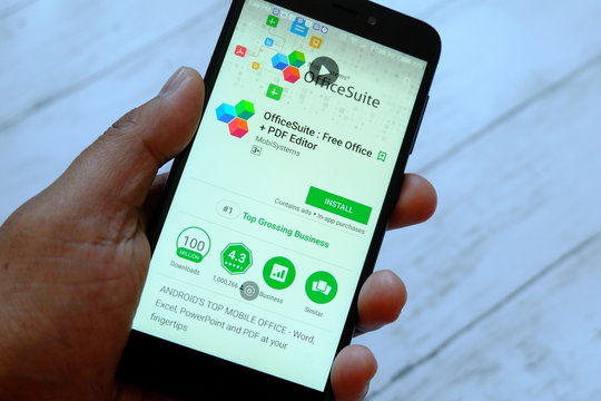 BANDAR SERI BEGAWAN,BRUNEI - JULY 25TH,2018 : A male hand holding smartphone with OfficeSuite app on an android Google Play Store.