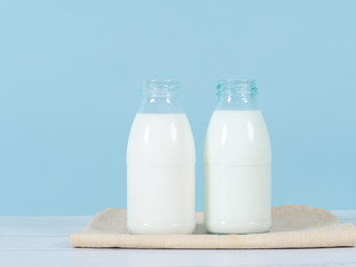 Milk bottle on table with blue background.