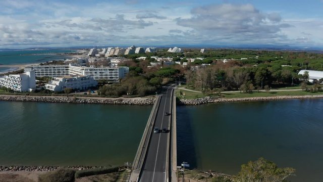 Bridge with la Grande Motte in background aerial view France mediterranean resort town