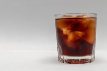A close up in a glass of cold cola,  isolated white background
