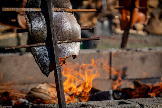 Salmon being  grilled over an open fire using a traditional native american technique at an event in Southern Oregon