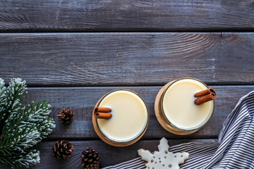 Eggnog - cute New Year composition with alcoholic drink on dark wooden background top view frame copy space