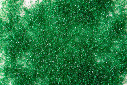 Christmas background, green baking sugar sprinkles on a white marble background