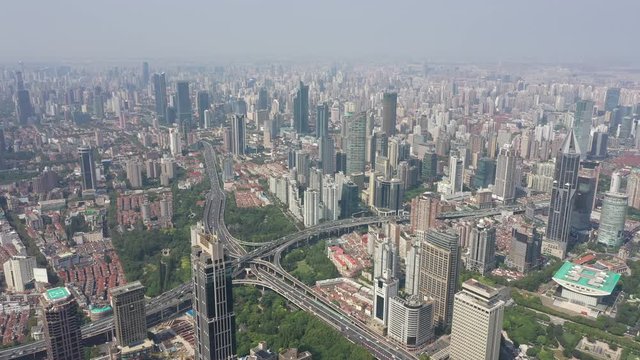 High angle aerial view of converging roads at Yan'an intersection and sprawling city of Shanghai, urban infrastructure in China