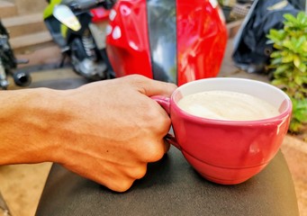 hands holding a cup of tea